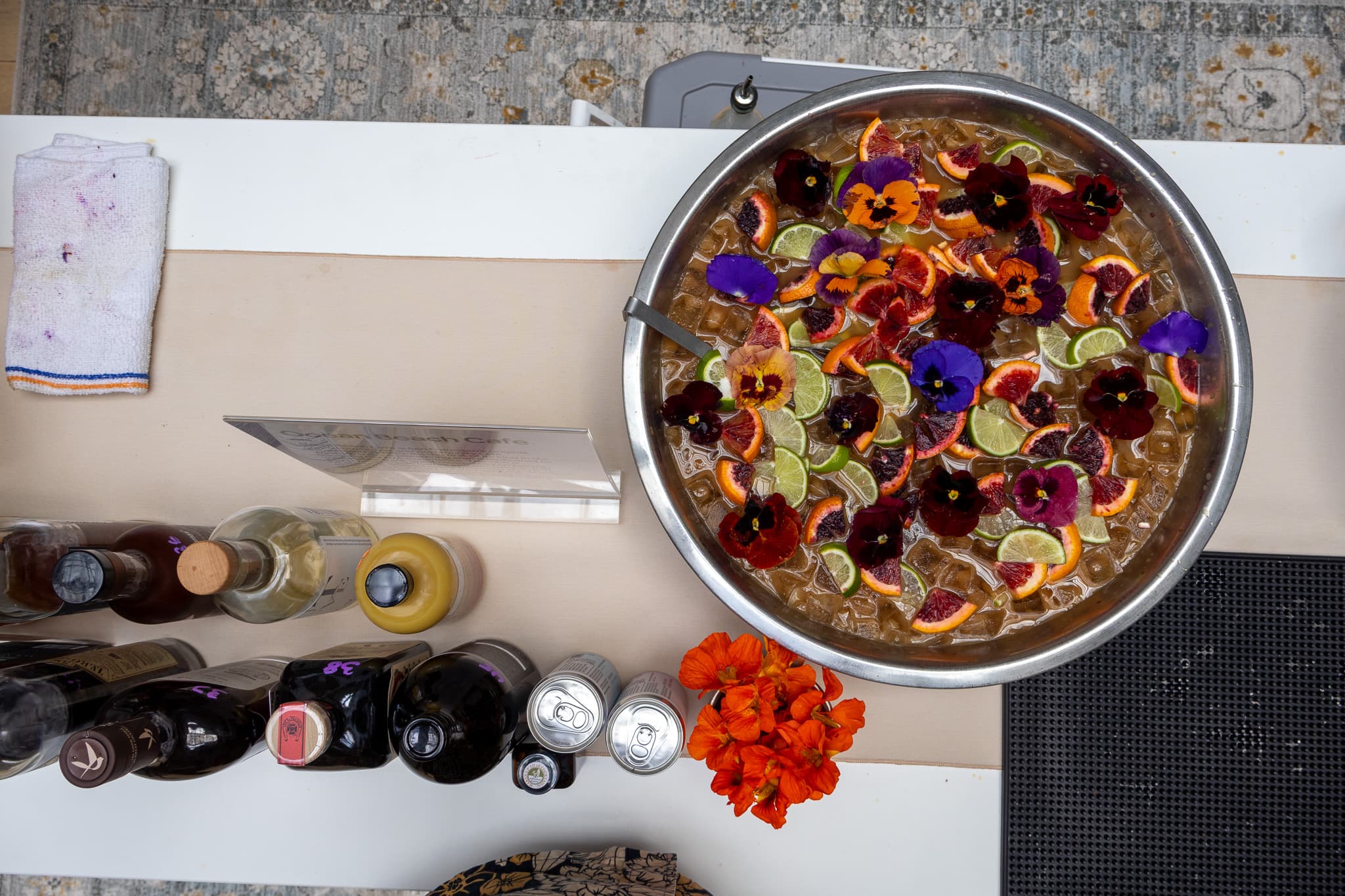 Beautiful punch bowl with edible flowers and citrus for corporate event